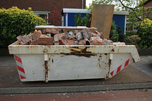 Skip hire site with delivered skips and staff preparing for work