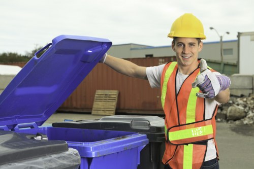 Operative wearing PPE segregating recyclable materials